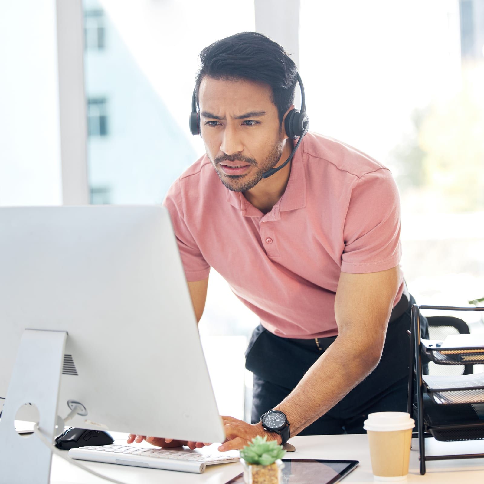 Agent on a headset working at a computer